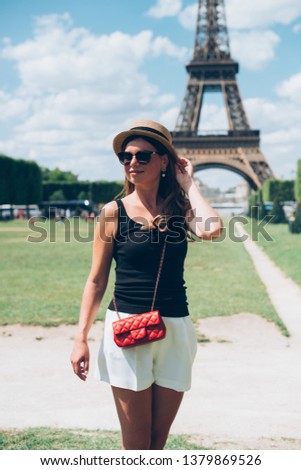 Paris woman happy and smiling, Fashion young blonde woman portrait in front of the Eiffel Tower in Paris, France.