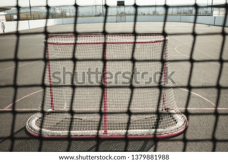 
Empty playground. Ball hockey net and blurry stadium. Close up detail of a playground for inlline hockey
