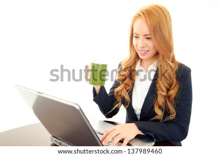 Smiling business woman using laptop