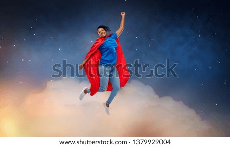 super power and people concept - happy african american young woman in superhero red cape flying over starry night sky and clouds background