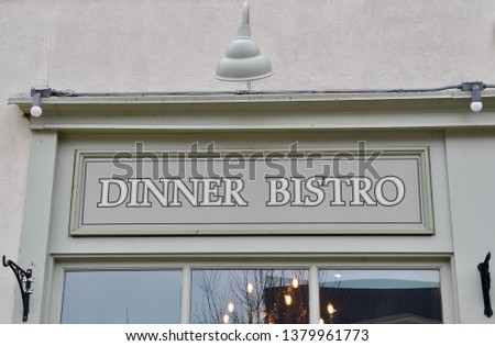 Dinner bistro signs in front of the building