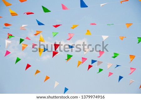 Colorful triangle flags with blue sky on songkran's festival is the Thai New Year's national holiday.