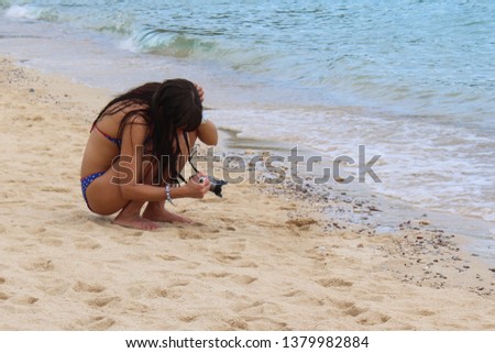 girl taking pictures on the beach