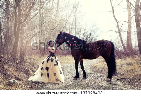 photo shoot of a beautiful girl and horse with a long mane in the forest