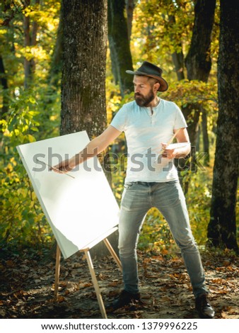 Art concept. Painting in nature. Start new picture. Painter with easel and canvas. Bearded man painter looking for inspiration autumn nature. Relax and hobby. Drawing from life. Painter artist forest.