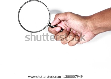 a hand holding a science tools which is call magnifying glass for looking on small stuff.