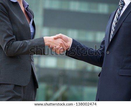 Businessman and businesswoman handshake showing trust and friendship