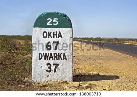 Milestone of the coastal road to Dwarka in Gujarat India, the 37 kilometers Milestone to Dwarka on the state highway 25 which runs through some of the most  barren and wilderness part of the country Royalty-Free Stock Photo #138003710