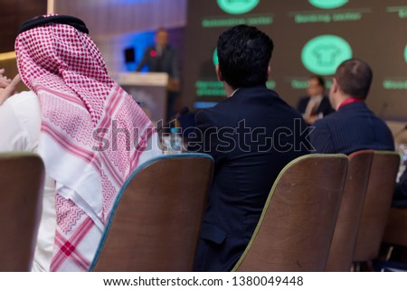 Business Conference and Presentation,Arabic businessman representing model of economic development and startup business, Audience at the big conference hall. Royalty-Free Stock Photo #1380049448