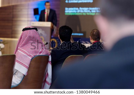 Business Conference and Presentation,Arabic businessman representing model of economic development and startup business, Audience at the big conference hall. Royalty-Free Stock Photo #1380049466