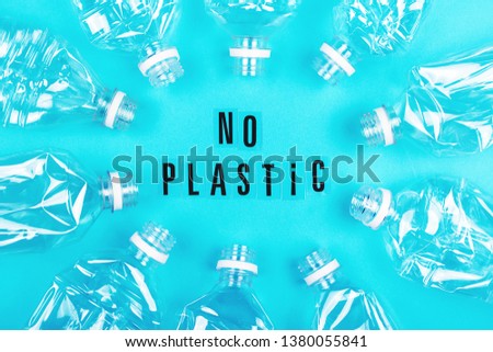 Plastic free and zero waste concept. Many empty plastic bottles on blue background and no plastic letters. Flat-lay, top view. 