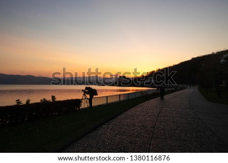Silhouette photographer in morning at Toya Lake Hokkaido Japan