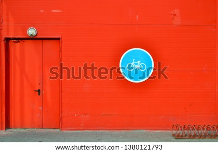 round road sign bicycle bike parking on red wooden scratch wall door street vintage background