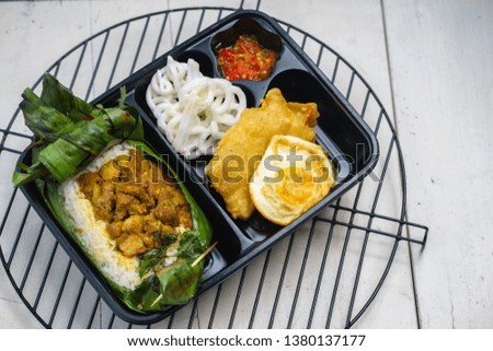 Nasi bakar or roasted rice served with banana leaves as the wrappers, traditional Indonesian food.
