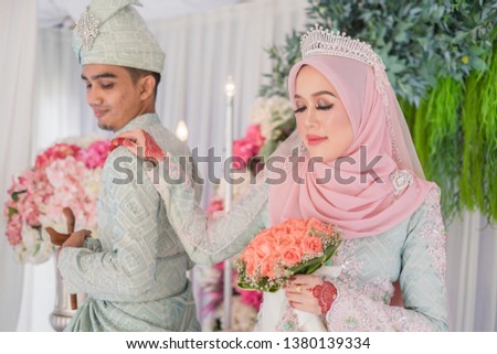 Muslim wedding couple wearing Malay traditional  dress on Malay wedding ceremony