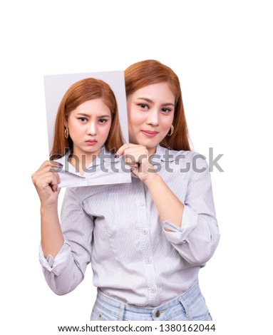 bipolar disorder concept. lonely young Asian woman with happy face holding face mask to show unhappy feeling for 2 different emotion Royalty-Free Stock Photo #1380162044
