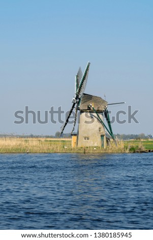 Waterways of North Holland and view on traditional Dutch wind mill, Dutch lifestyle landscape