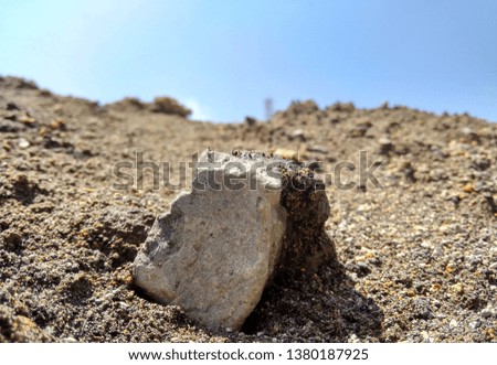 Photos of the scenery during the day, a rock found in sand dunes during the summer. This natural scenery is suitable for background, wallpaper, etc.