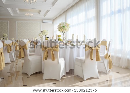 Decorated wedding banquet hall in classic style. Restaurant interior for banquet, wedding deco Royalty-Free Stock Photo #1380212375