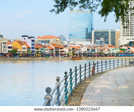 Colorful buildings of Boat Quay district and modern buildings facades view from Singapore embankment Royalty-Free Stock Photo #1380223667