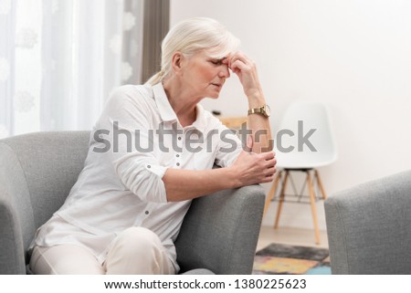 Older woman has a headache. Senior healthcare concept Royalty-Free Stock Photo #1380225623