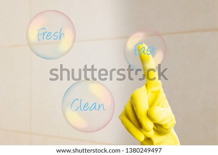 Index finger wearing yellow gloves touching fast text bubble shaped button on invisible display