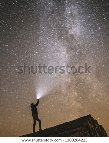 Star photography in germany, 30 seconds exposure. Man holding a light to the galaxy