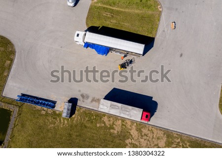 Aerial view of trucks and trailers. Distribution logistics buildings 