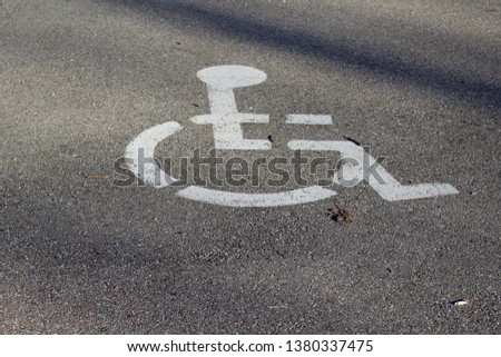 A close view of the handicap icon on the concrete surface.