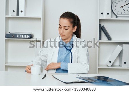 Personal doctor at the desk with a cup of coffee medicine