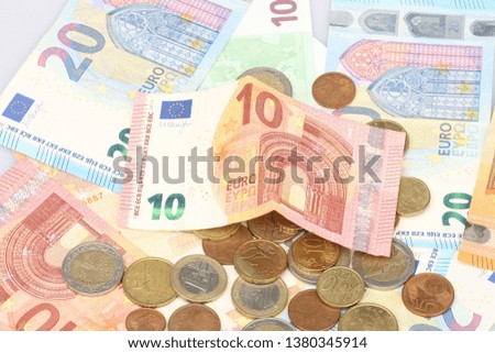 Micro loan offer. Little bit of European Union money. Metal coins of and paper banknotes design. Euro cash closeup on white background. Limited depth of field Close-up