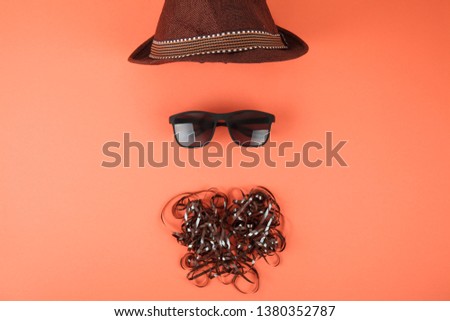 Sunglasses and beard from cassette tape. Summer background. Creative layout