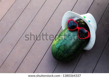watermelon fruit in heart sunglasses in summer.
