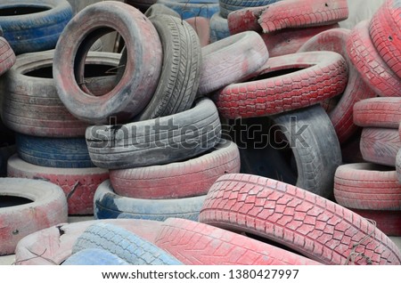 A picture of many old used tires left on a waste dump