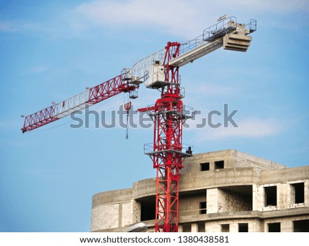 Crane. Construction crane. Building crane on the background of building. Construction site.