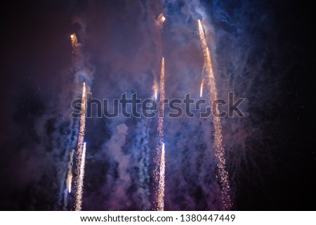 Explosive and colorful holiday fireworks at night sky. Celebration City Holiday. Pyrotechnic smoke and bright flashes
