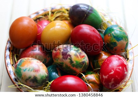 Colorful Easter eggs in a plate on wooden background 1