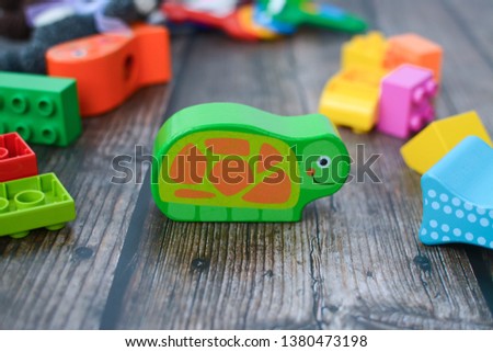 Colorful baby toys on dark wooden floor
