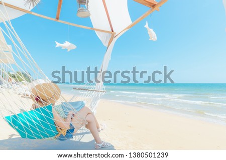 Woman relaxing in hammock on the beach,Summer vacation and travel concept