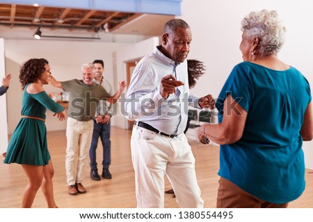 People Attending Dance Class In Community Center Royalty-Free Stock Photo #1380554495