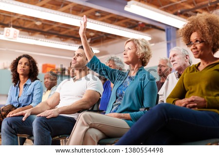 Woman Asking Question At Neighborhood Meeting In Community Center Royalty-Free Stock Photo #1380554498