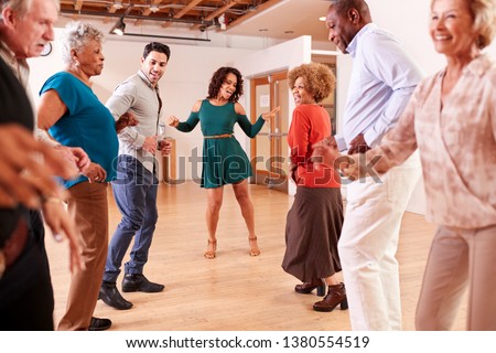 People Attending Dance Class In Community Center Royalty-Free Stock Photo #1380554519
