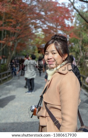 beautiful asia woman stand in autumn park at nara,japan