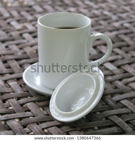 Coffee cup with lid to prevent insects from flying into the coffee seen in Vietnam