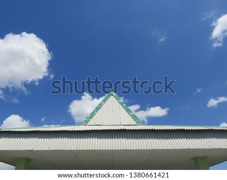 Triangular roof at bottom frame against Clear sky blue background isolated on a big small white cloud cotton texture seamless pattern wavy with sun reflection flare. Nature design elemental wallpaper