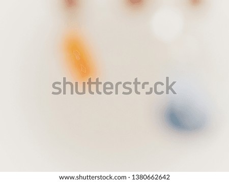Abstract of blurry picture of colourful stone chandelier on off white background with some bokeh with copy space for text