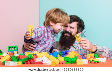 We like spending time together. small boy with dad playing together. happy family leisure. building with constructor. child development. father and son play game. vacation time. free time on vacation.