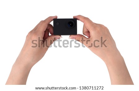 Action camera on a white background. Black portable camera closeup in hands on a white background.