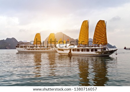 Discover Halong Bay Top Destinations Vietnam. Cruse liner golden Sails liner ship wooden junk sailing rock islands the emerald waters of Ha Long Bay. Royalty-Free Stock Photo #1380716057
