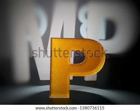 the golden "P" letter, the background looks blurry